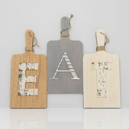 Three decorative paddle signs with letters 'E', 'A', and 'H' on a white background.