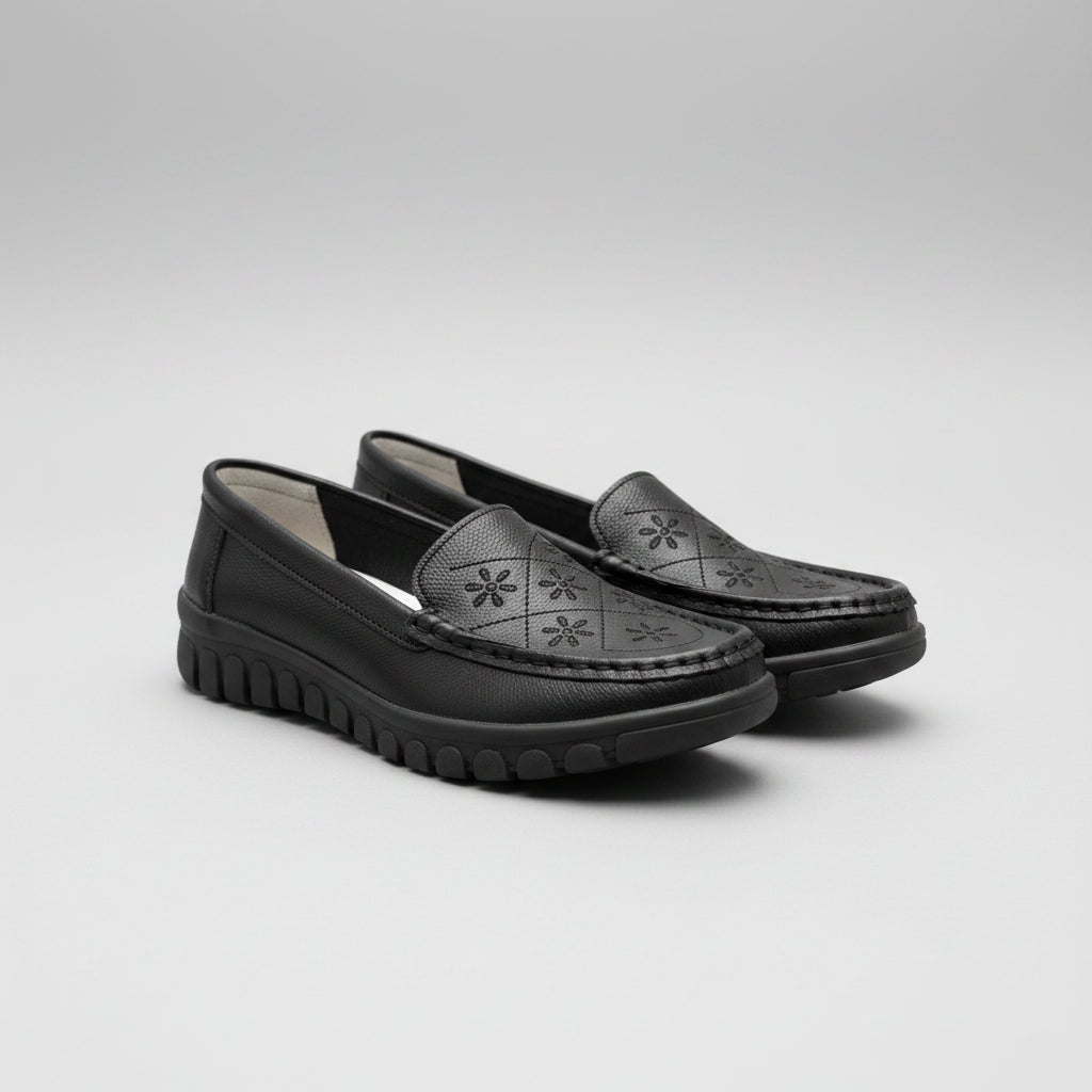 Black shoes on a beige surface with a blurred background