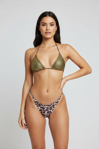 Bikini set with leopard print bottom and green top on a wooden surface, with tags attached.