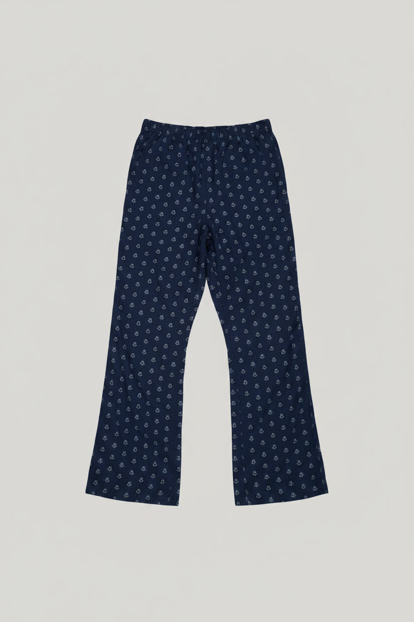 Blue patterned pants on a gray carpet