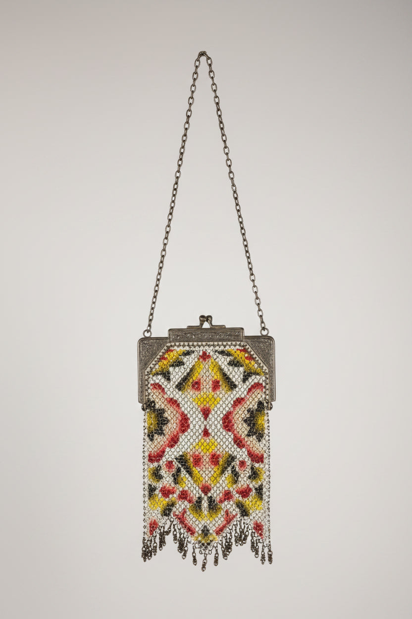 Decorative handbag with intricate beadwork on a textured surface