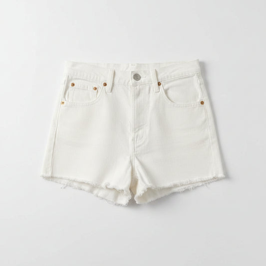 White denim shorts on a textured gray surface