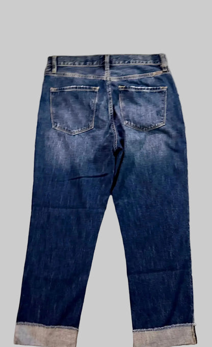 Back view of a pair of blue jeans on a white background