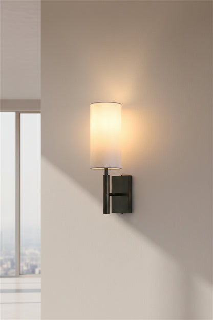 Wall-mounted lamp with a white shade on a plain wall